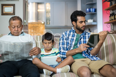 Family relaxing while sitting on sofa