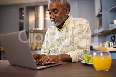 Smiling man using laptop