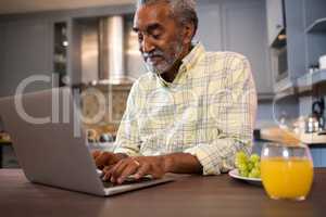 Smiling man using laptop