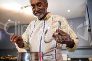 Senior man preparing food at home
