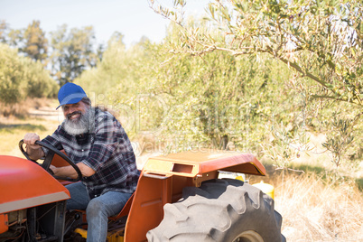 Portrait of happy man sitting in tractor