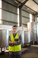 Portrait of confident technician standing with arms crossed