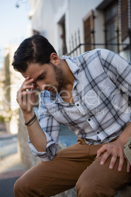 Tensed man with head in hand