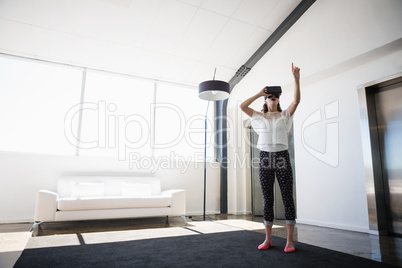 Full length of businesswoman using virtual reality simulator