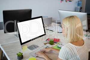 Woman using computer while working at office