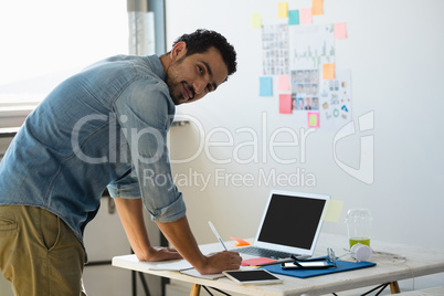 Side view portrait of man working at office
