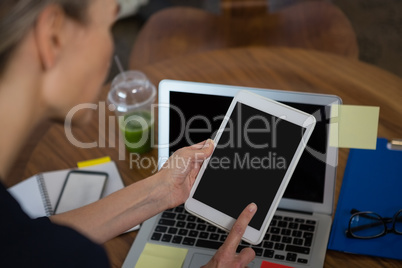 Cropped image of businesswoman using tablet