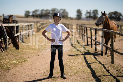 Girl standing with hands on hips in the ranch