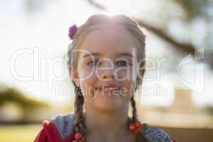 Cute little girl smiling at camera on a sunny day