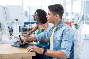 Graphic designers working on computer at desk