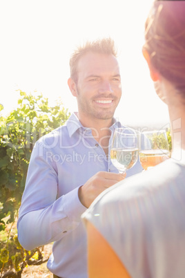 Smiling man with woman toasting wine