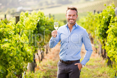 Portrait of handsome young man holding wineglass