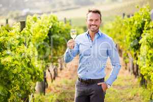 Portrait of handsome young man holding wineglass