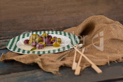 High angle view of black and green olives served in plate