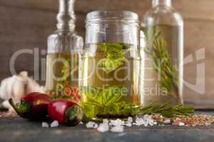 Close up of Ingredients by herb with oil in container