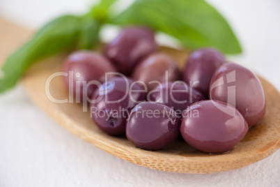 Close up of brown olives in spoon