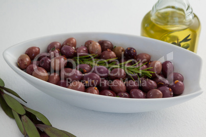 Olives and rosemary with oil in jar