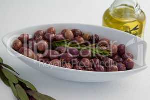 Olives and rosemary with oil in jar