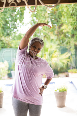 Portrait of smiling senior woman exercising