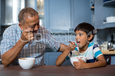 Grandfather and grandson having breakfast