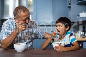 Grandfather and grandson having breakfast