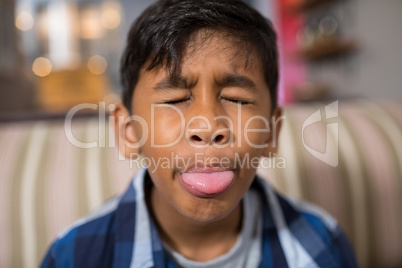 Close up of boy sticking out tongue