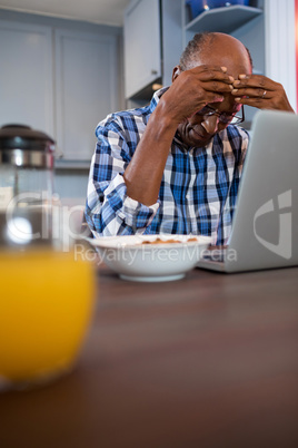 Worried man using laptop