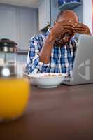 Worried man using laptop