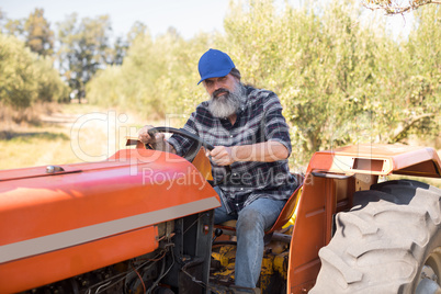 Portrait of confident man sitting in tractor