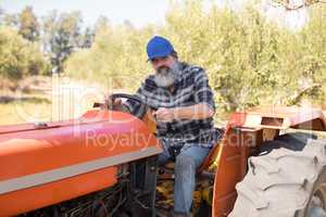 Portrait of confident man sitting in tractor