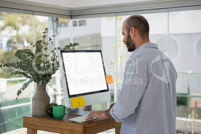 Side view of designer using computer