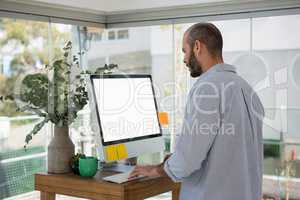 Side view of designer using computer