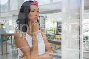 Thoughtful businesswoman looking through window