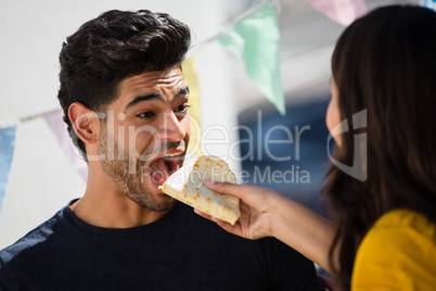 Woman feeding tortilla to friend