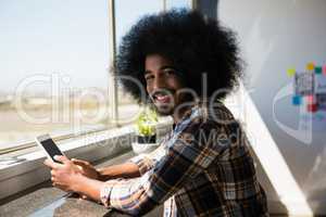 Portrait of smiling businessman using digital tablet