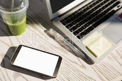 High angle view of laptop and mobile phone on desk