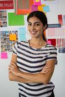 Portrait of confident young woman against sticky notes in office
