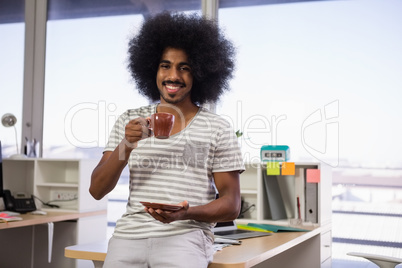 Portrait of man having coffee in office