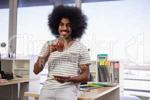 Portrait of man having coffee in office