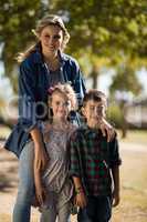 Happy mother and kids standing together in park