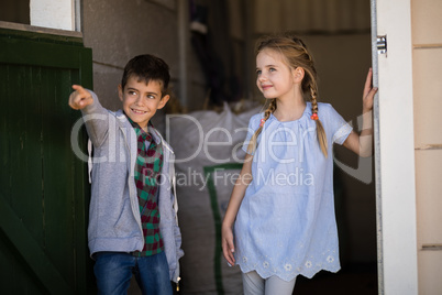 Boy and girl talking at each other in the stable