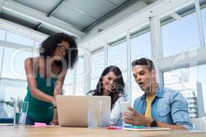 Executives working on laptop in the office