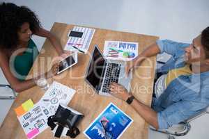 Male and female executives working in the office