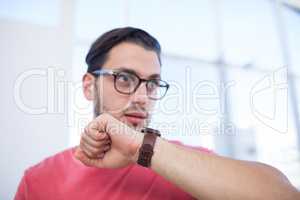 Male executive using smartwatch in the office