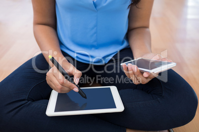 Graphic designer using stylus on digital tablet