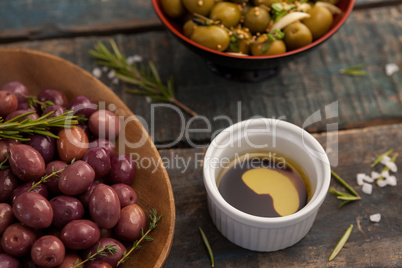 High angle view of olives with drink on table