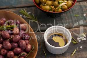 High angle view of olives with drink on table