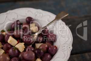 Cropped image of black olives served in plate