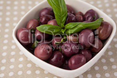 Close up of brown olives with herb