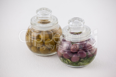 High angle view red and green olives in glass jar